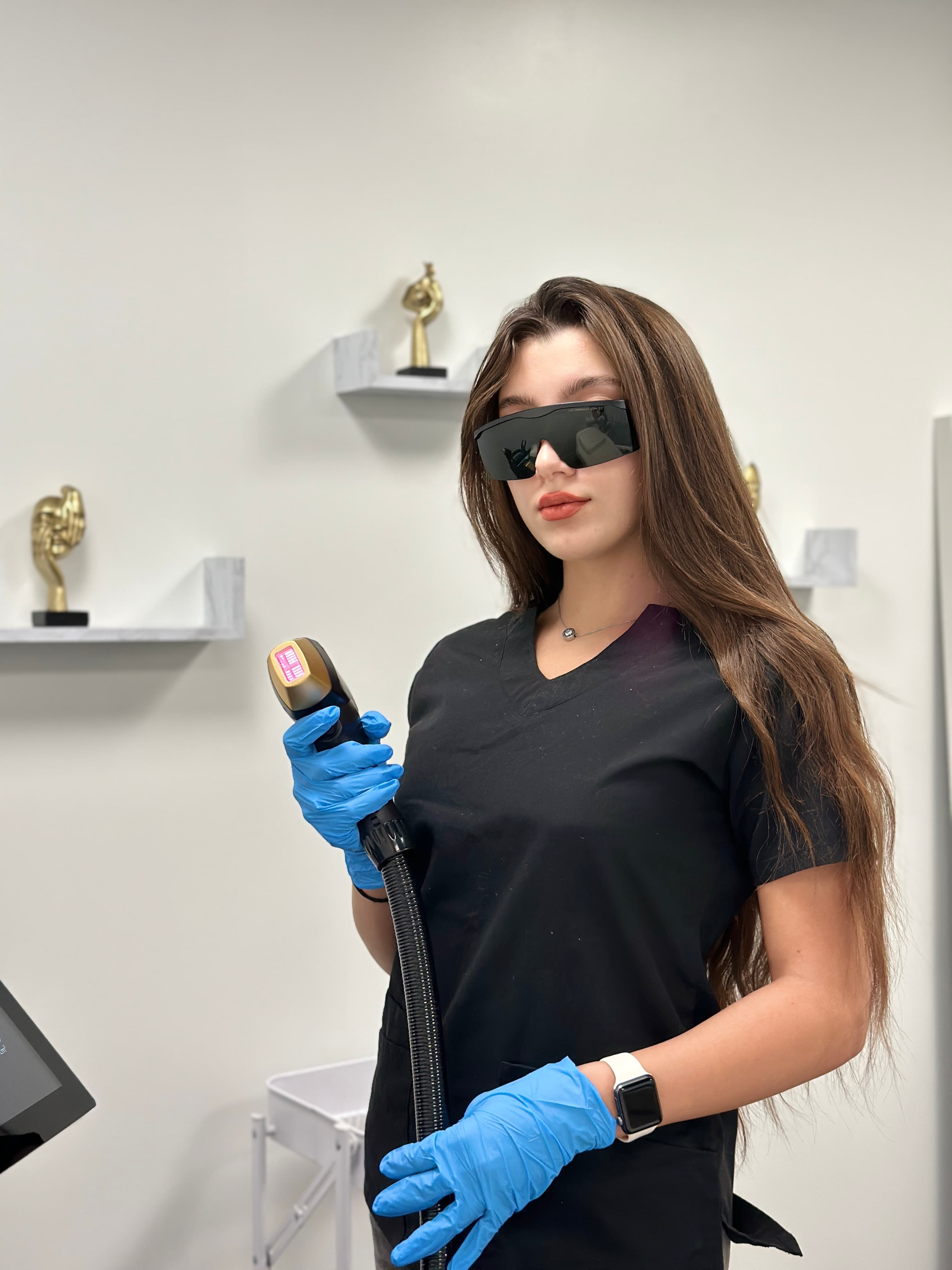 Laser VA specialist holding the laser device in the Glendale studio
